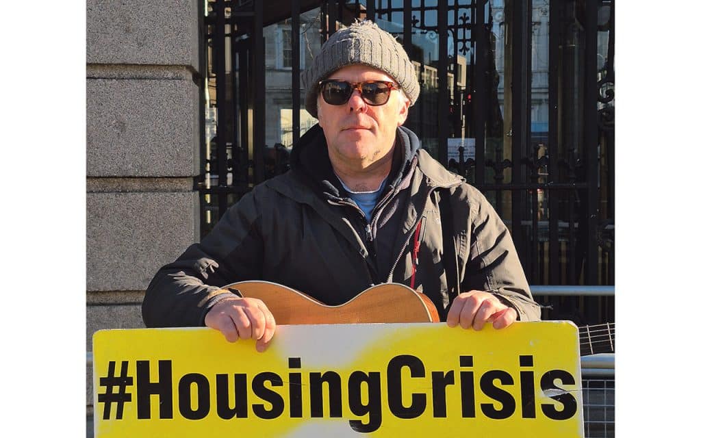 Martin Leahy at The Dáil with his guitar and 'housing crisis' sign